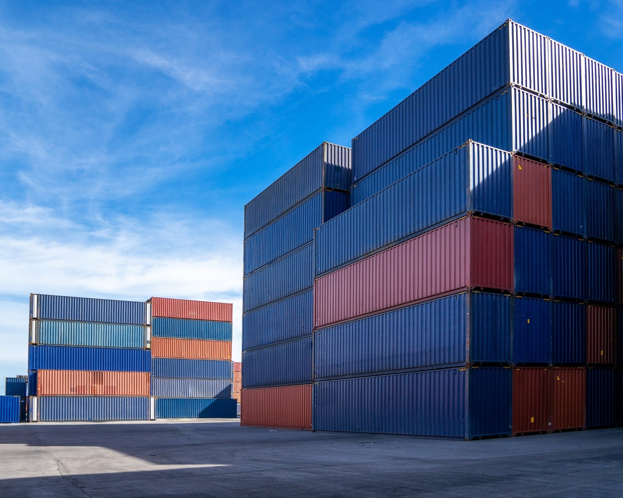 Stacked freight containers at a logistics yard